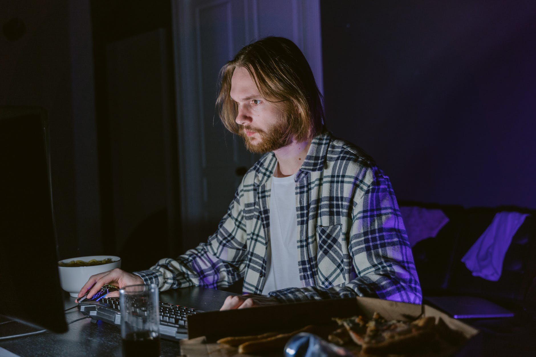 a man sitting at a table using a computer